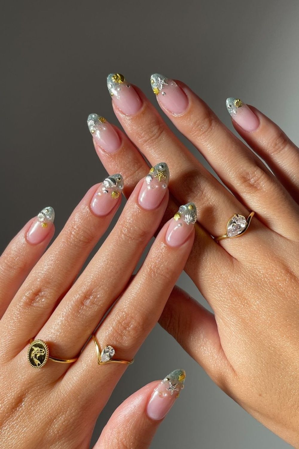 Beach-themed french nails with ocean charms