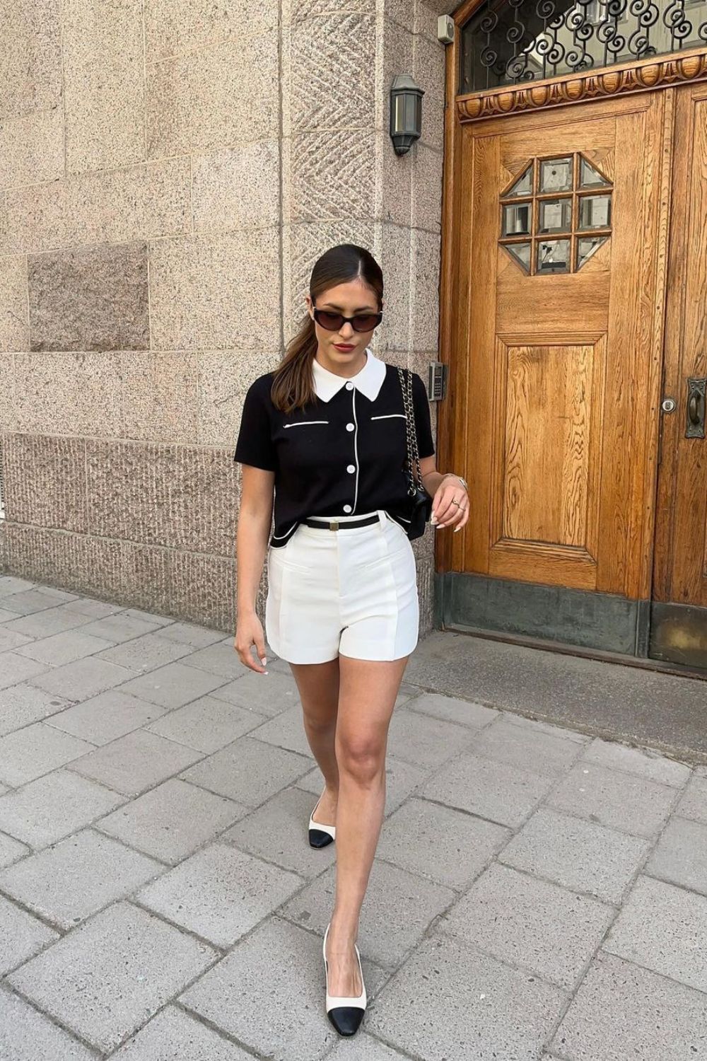 Black collared shirt and white shorts