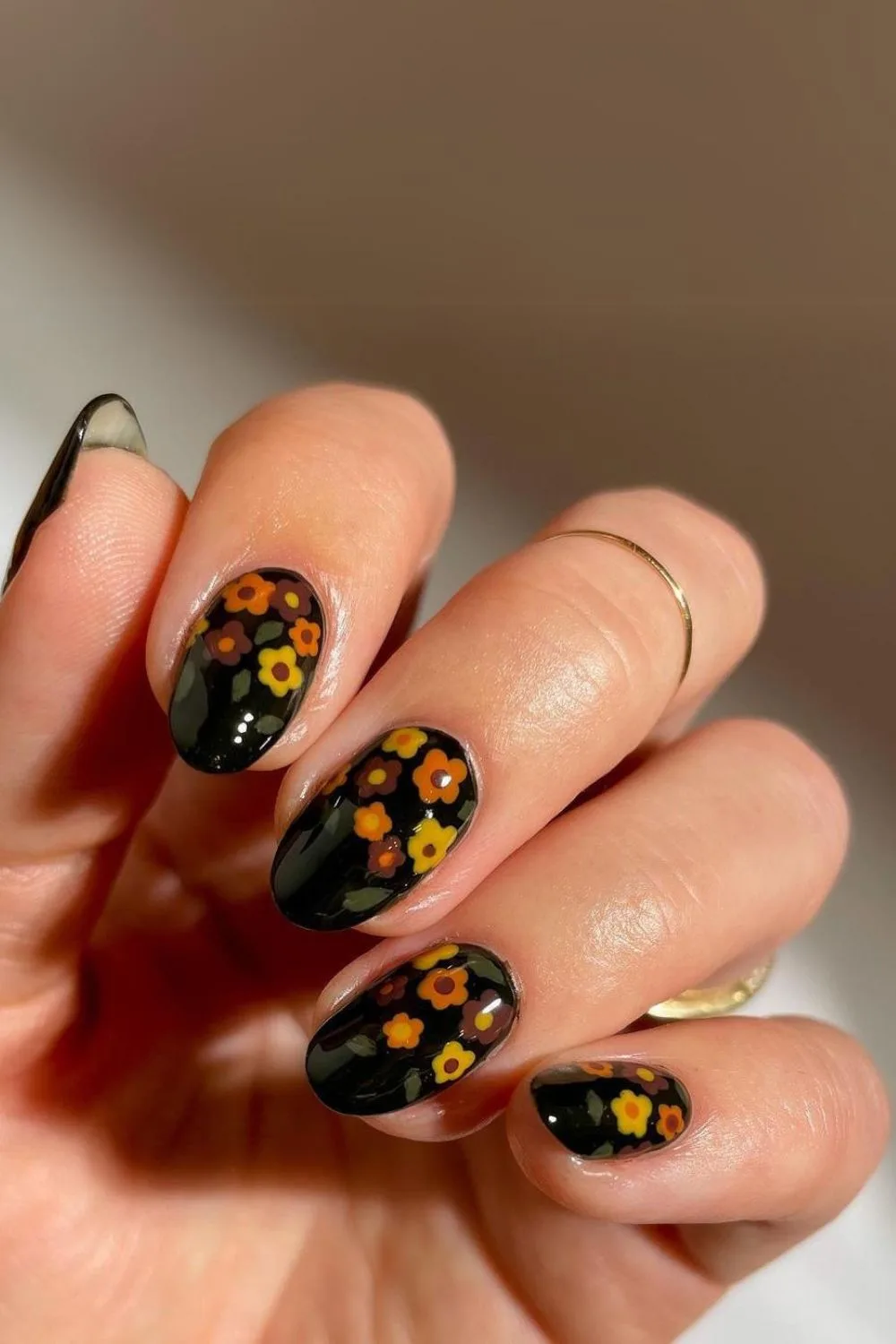 Black nails with colorful floral pattern