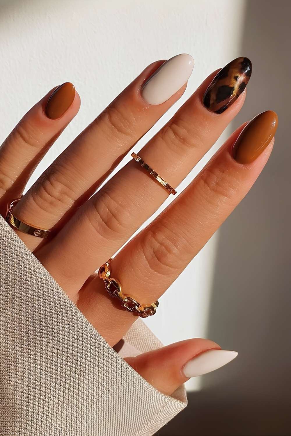 Brown and white nails with tortoise shell accent