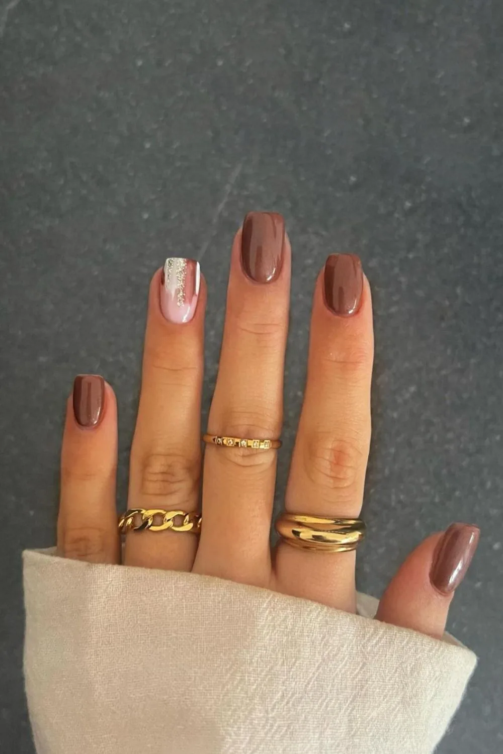 Brown mani with glittery accent nail