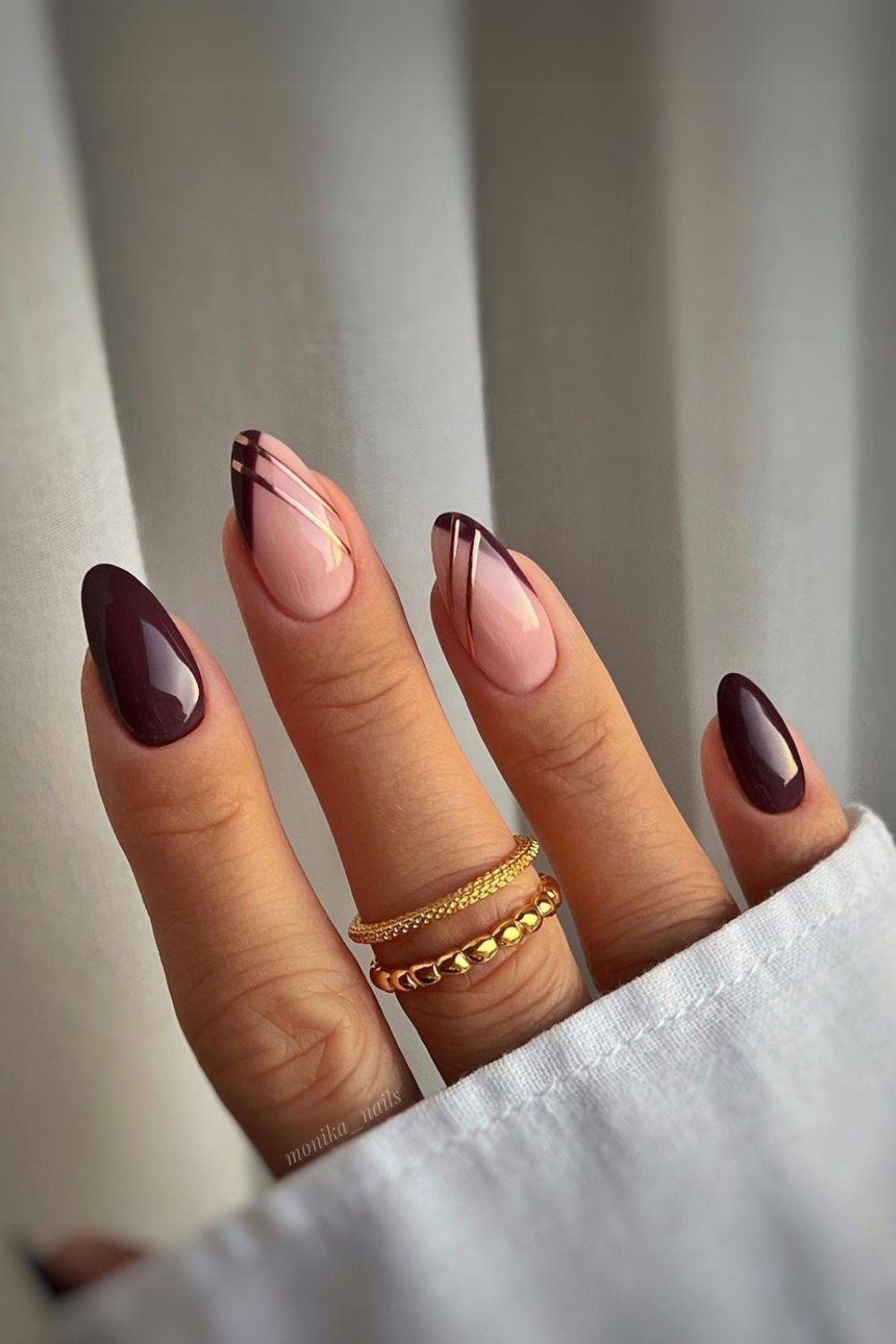 Dark brown pointed French tips with gold chrome lines