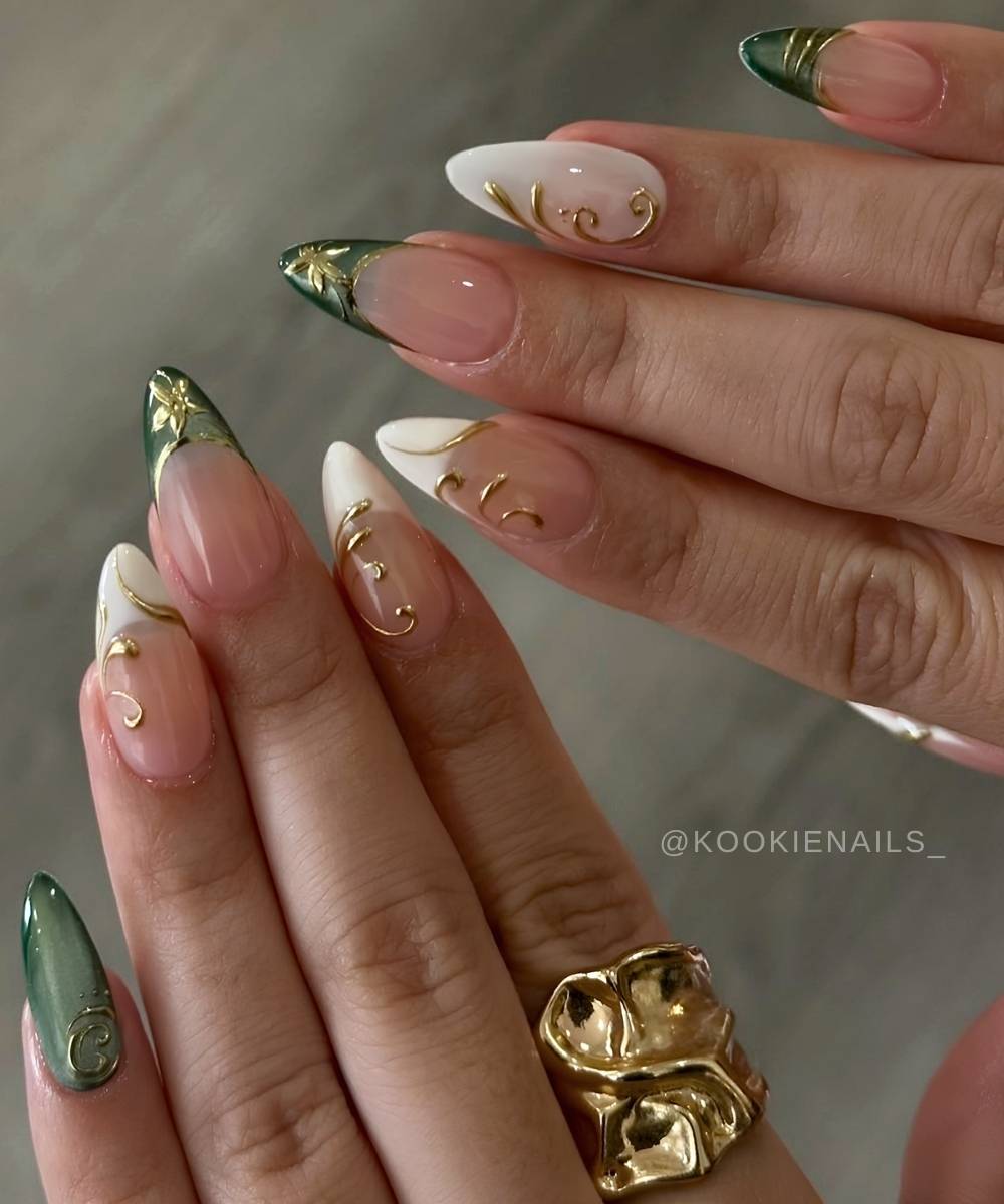 Dark green cat eye nails with white and gold accents