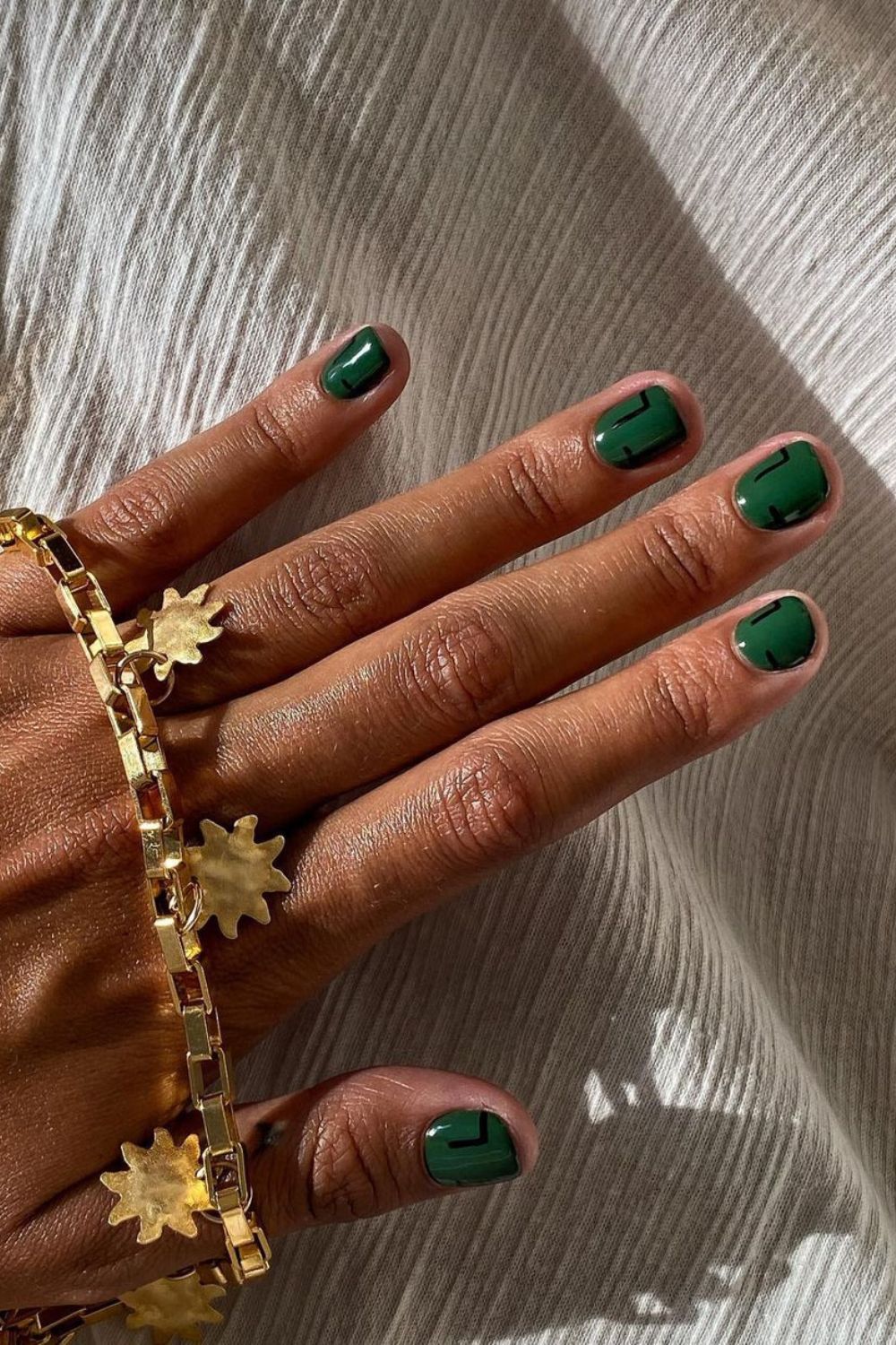 Dark green nails with abstract accents