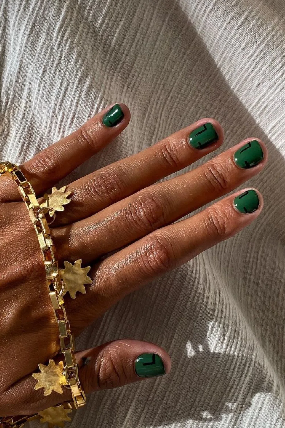 Dark green nails with abstract accents