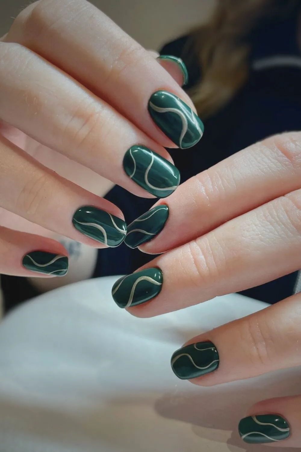 Dark green nails with abstract swirls