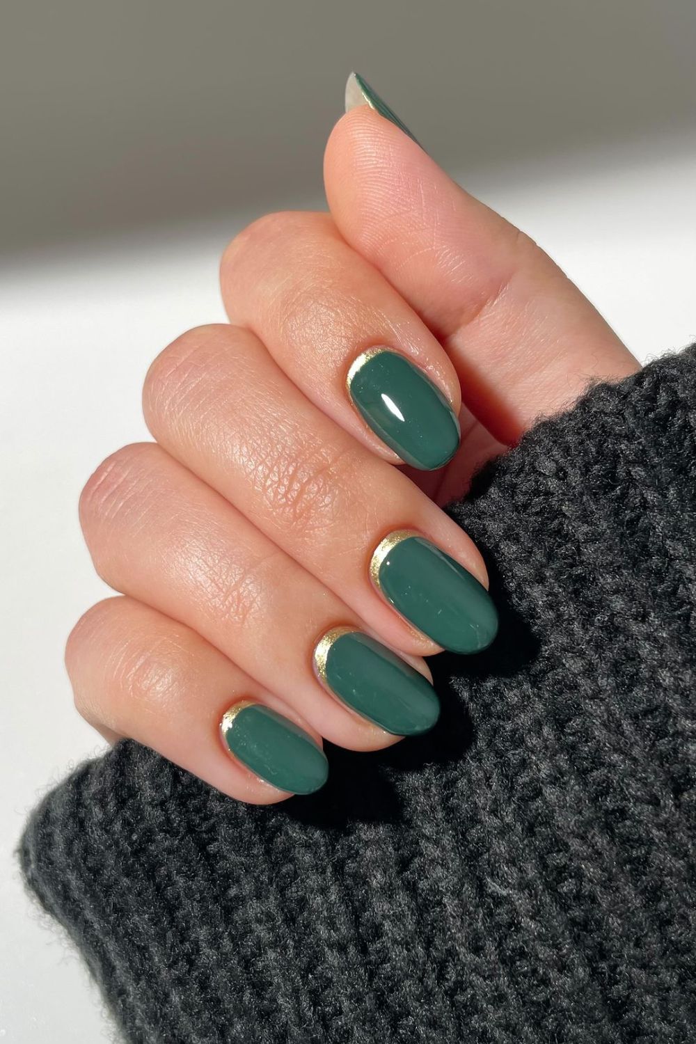 Dark green nails with gold accent