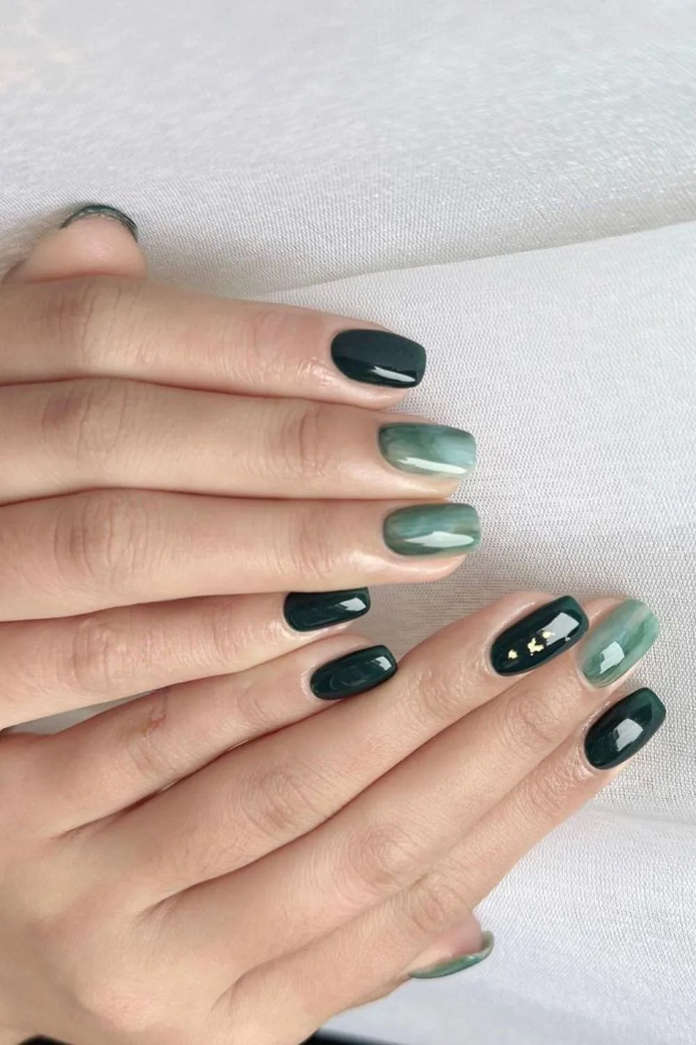 Dark green nails with jelly marble accents