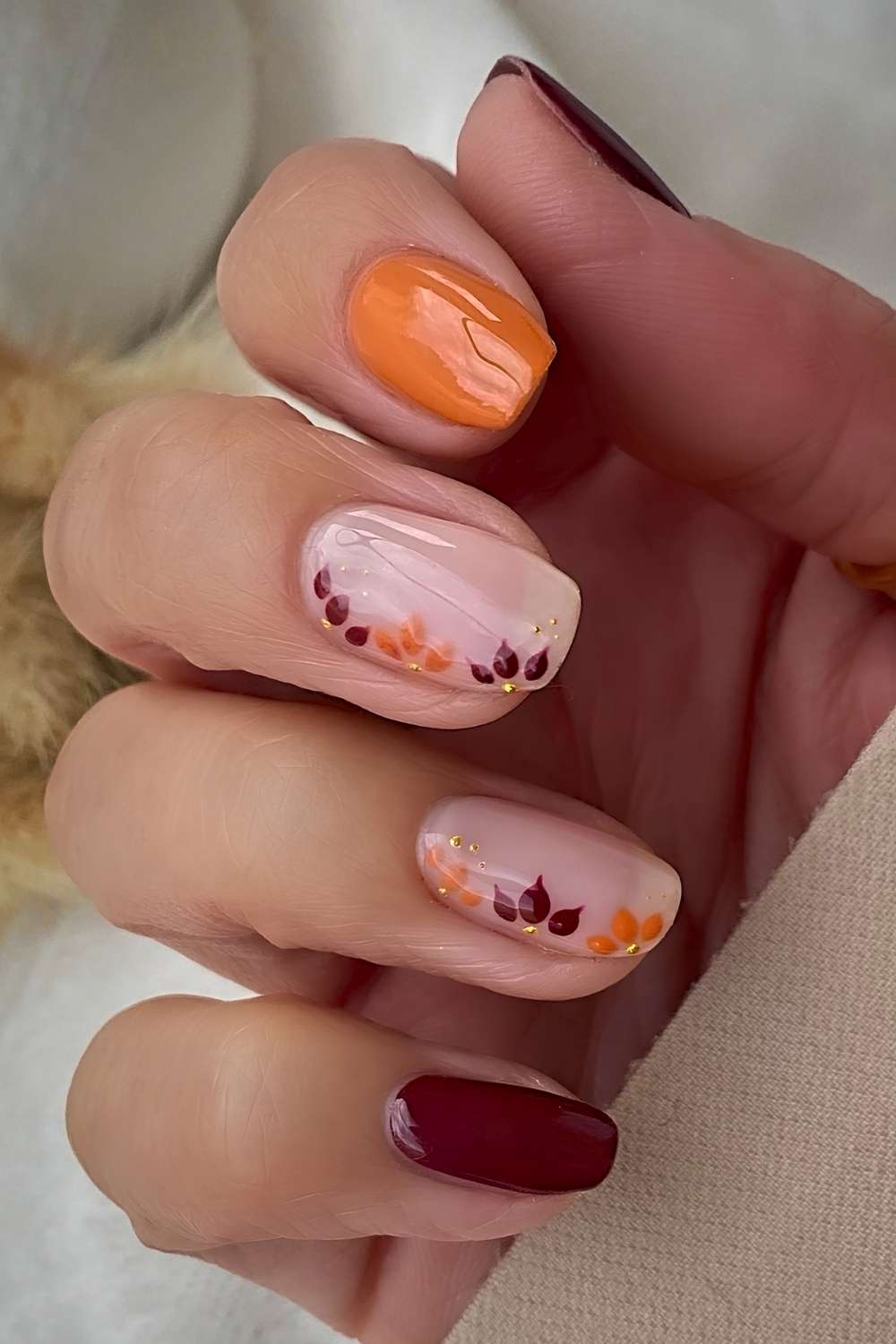 Deep red and pumpkin orange floral nails