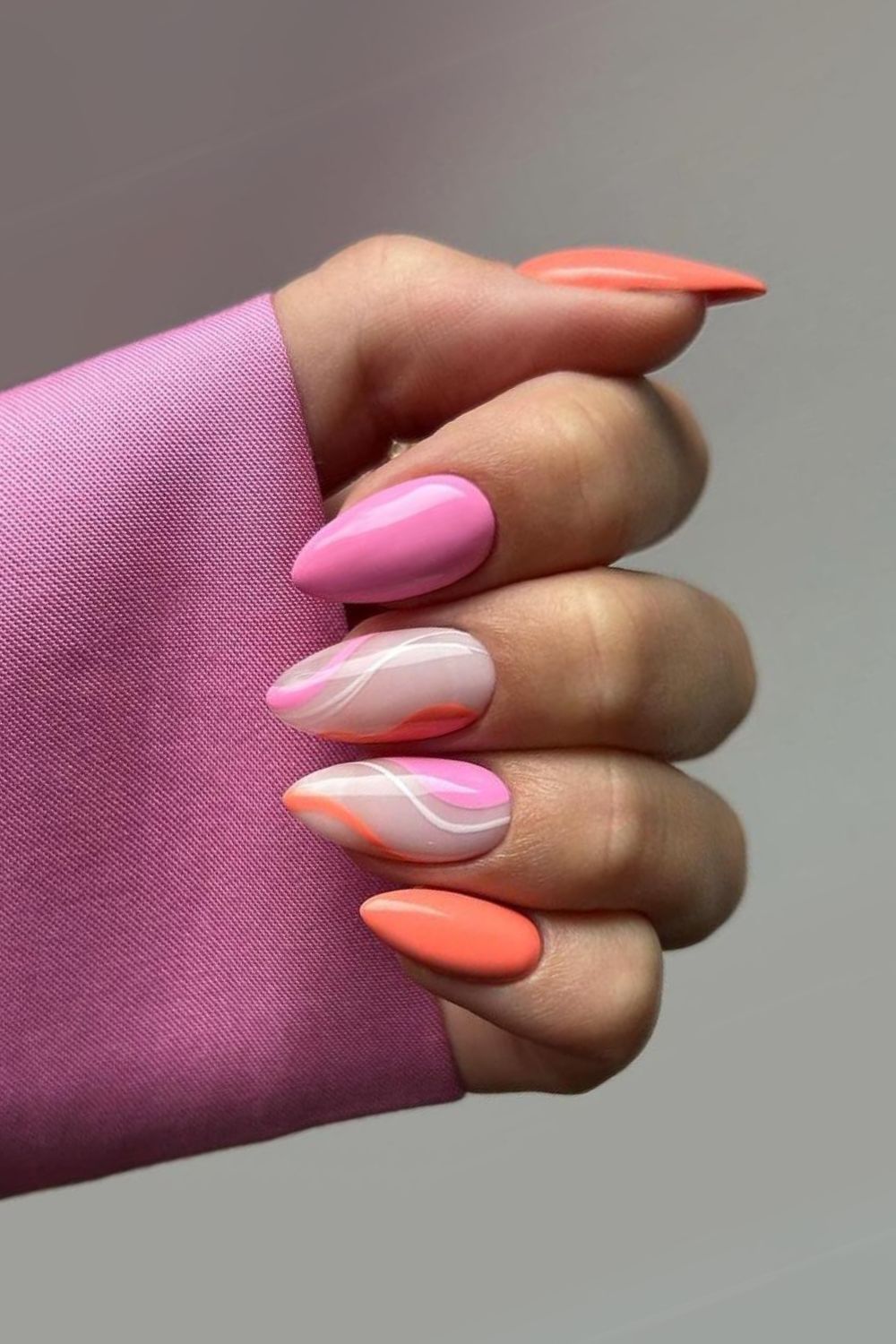 Elegant pink and orange nails with swirls