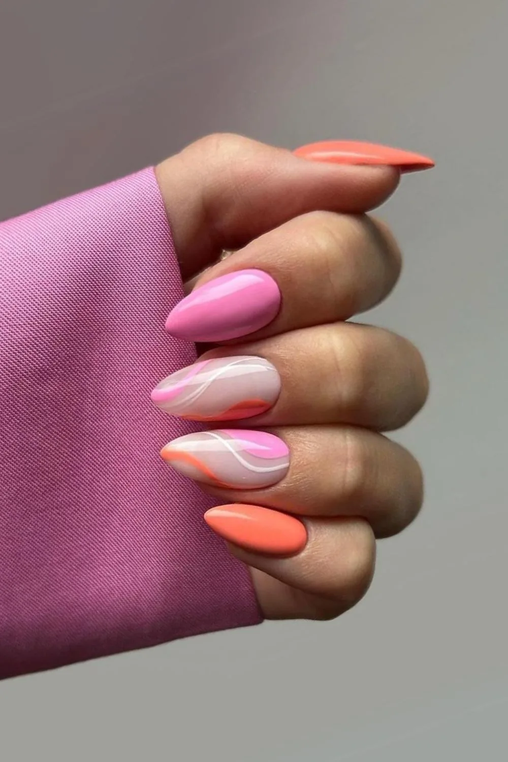 Elegant pink and orange nails with swirls