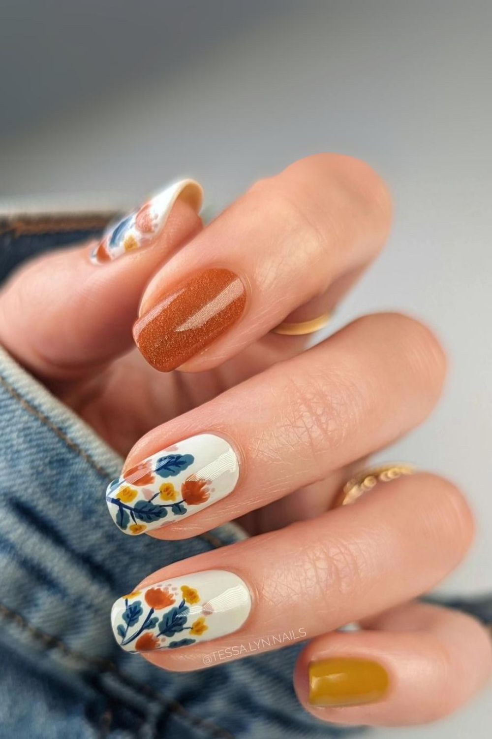 Flower-decorated white and mustard nails