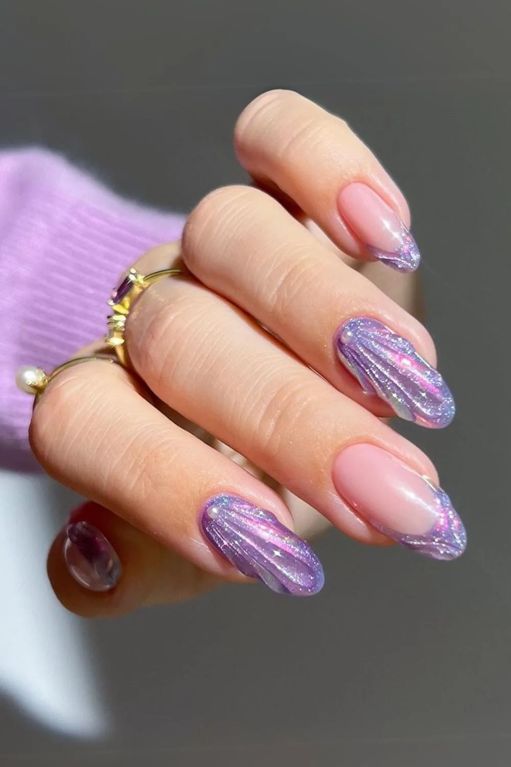 Glittery purple nails with seashell design