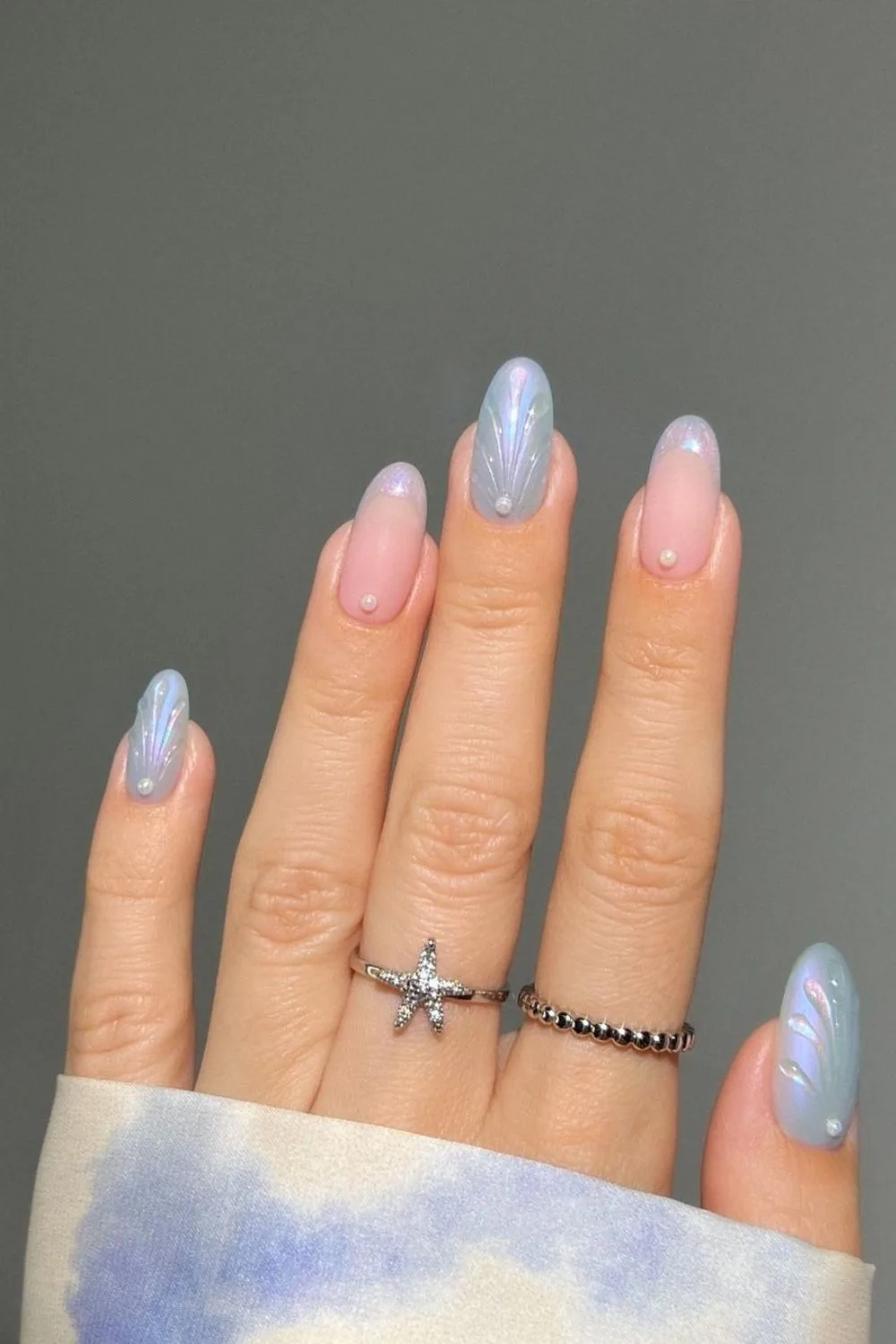 Iridescent blue nails with seashell design