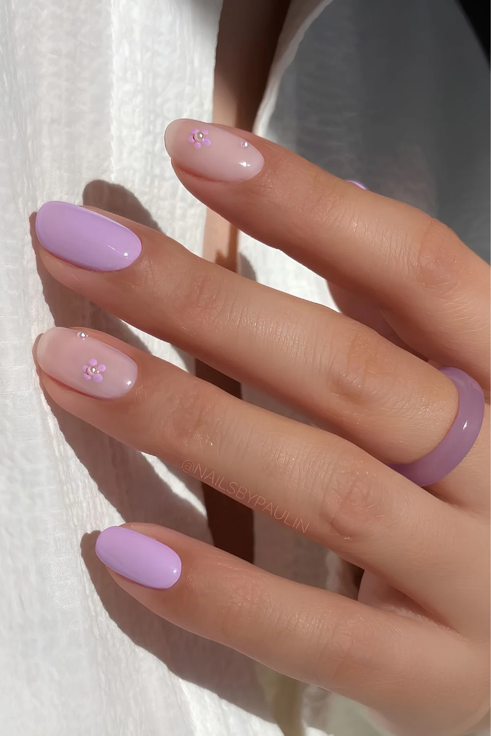 Lilac nails with pearl and flower accents