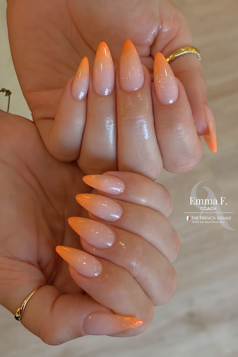 Milky white base with orange ombre nails and subtle shimmer