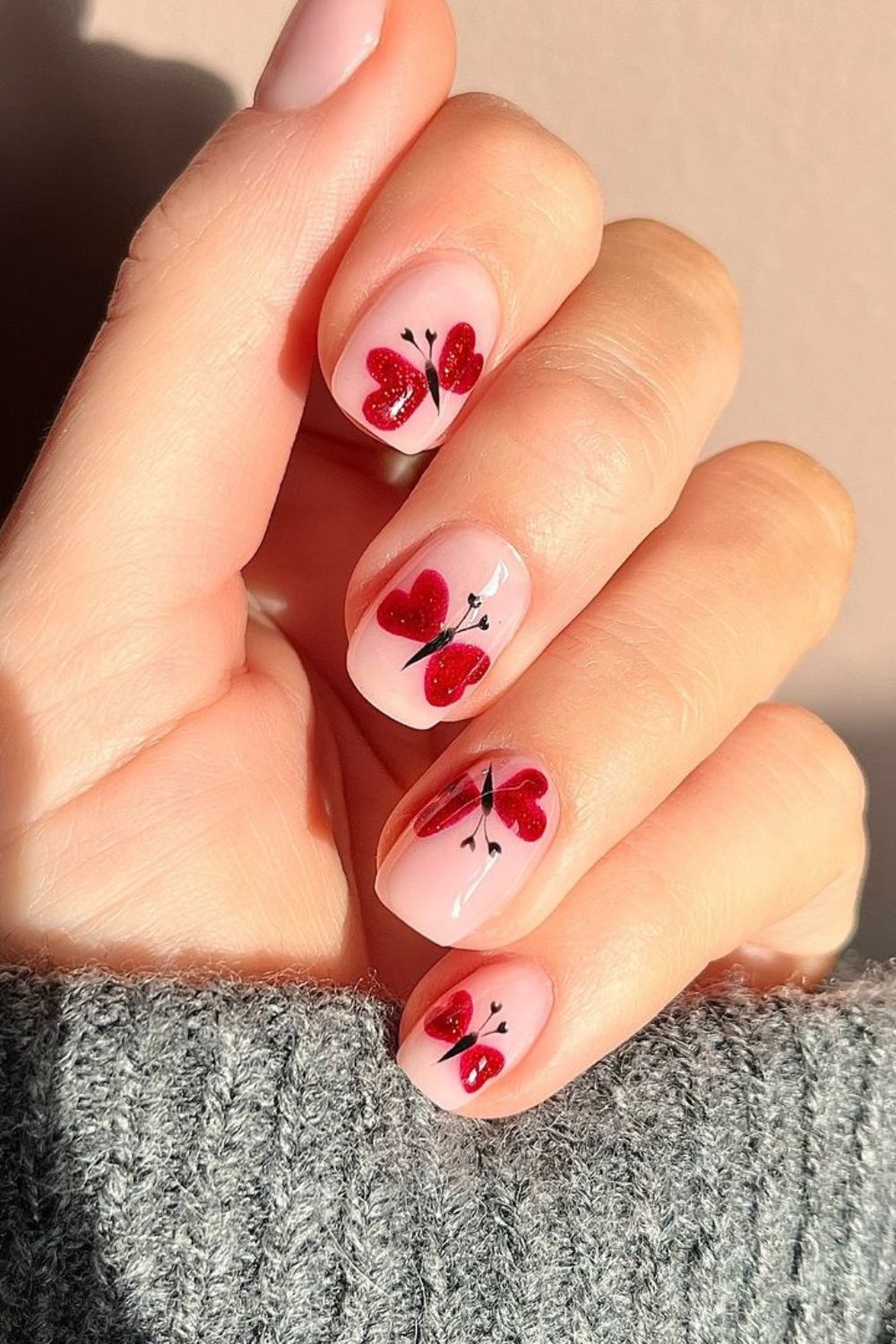 Nail with red butterflies