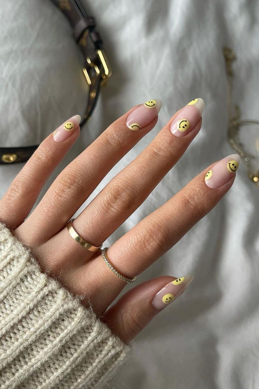 Nude nails with yellow smiley faces