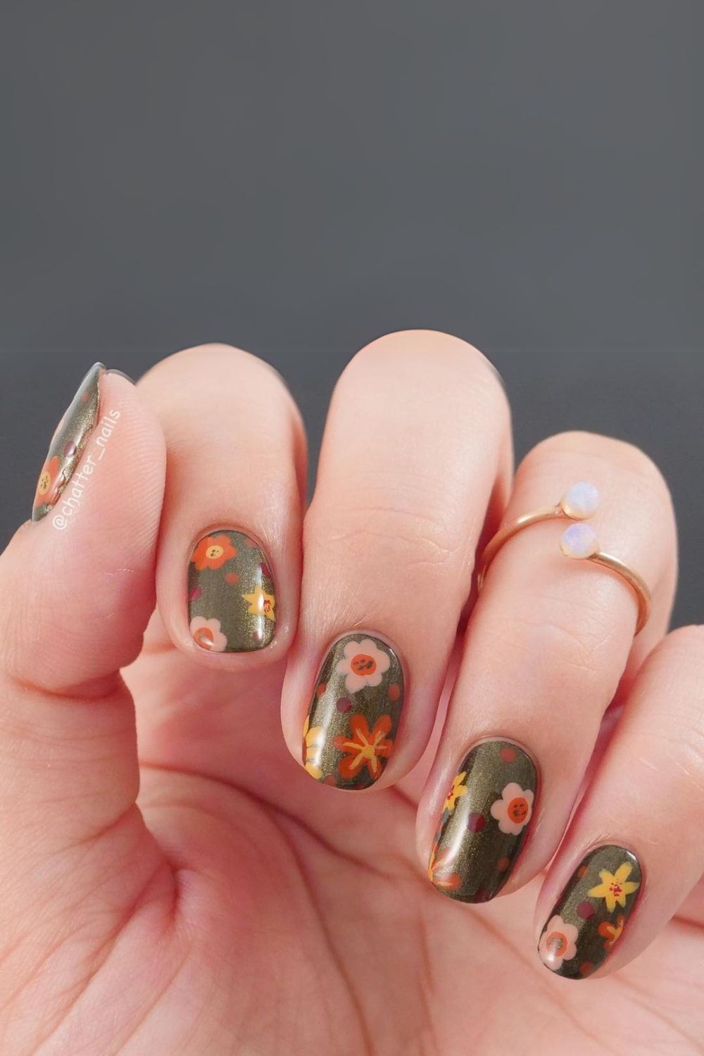 Olive green nails with floral pattern