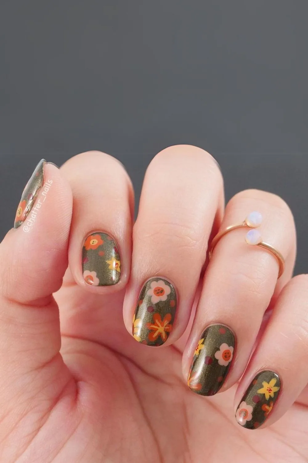 Olive green nails with floral pattern