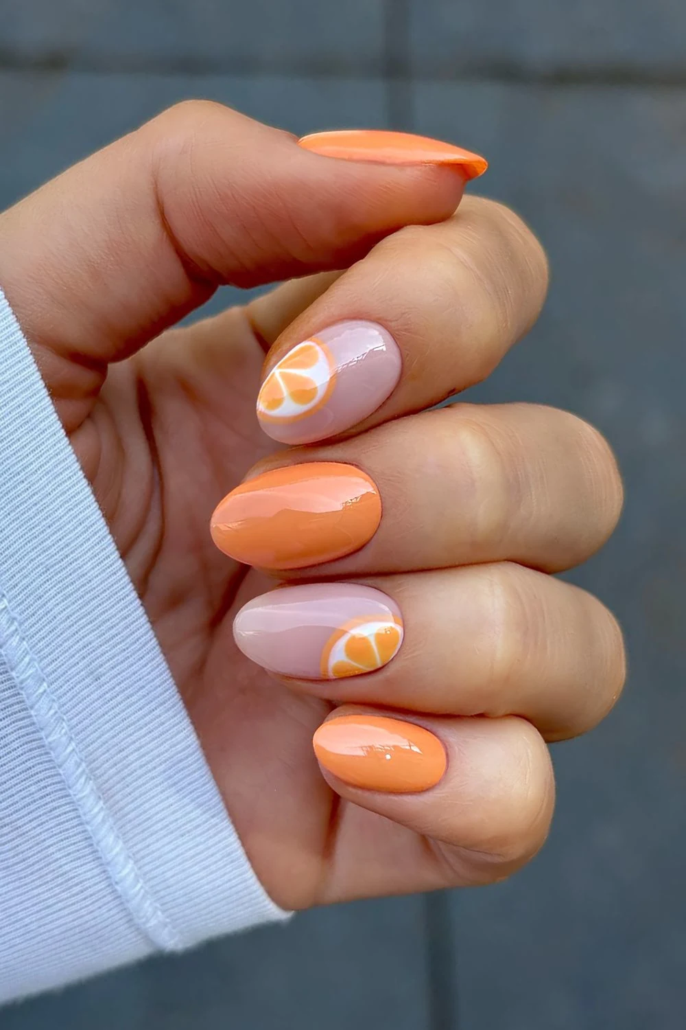 Orange and milky pink nails with orange slice accents