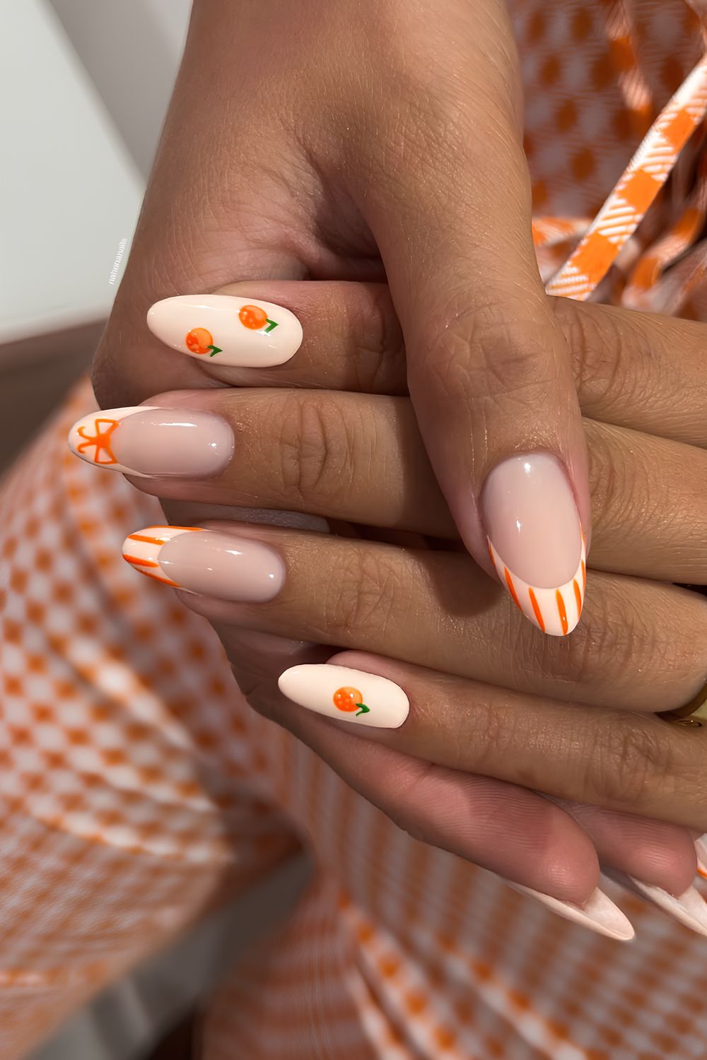 Peach nails with stripes and orange fruit art