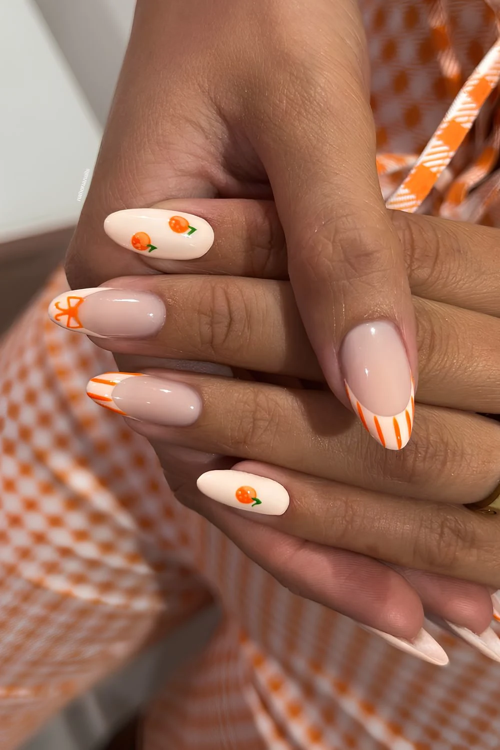 Peach nails with stripes and orange fruit art