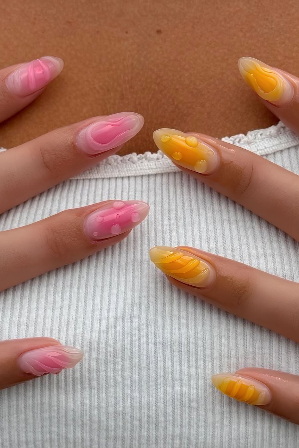 Pink and orange aura nails with 3d details