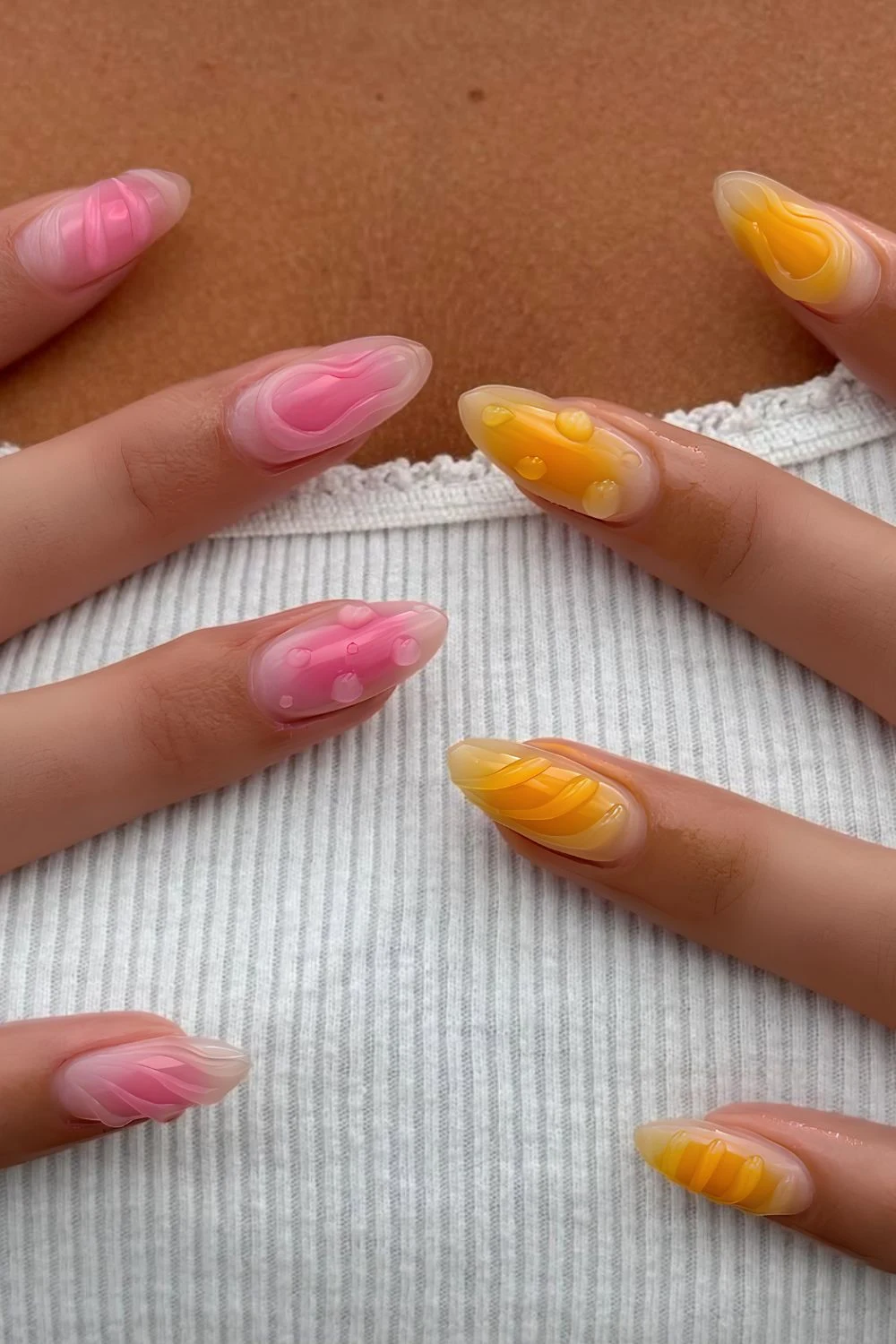 Pink and orange aura nails with 3d details