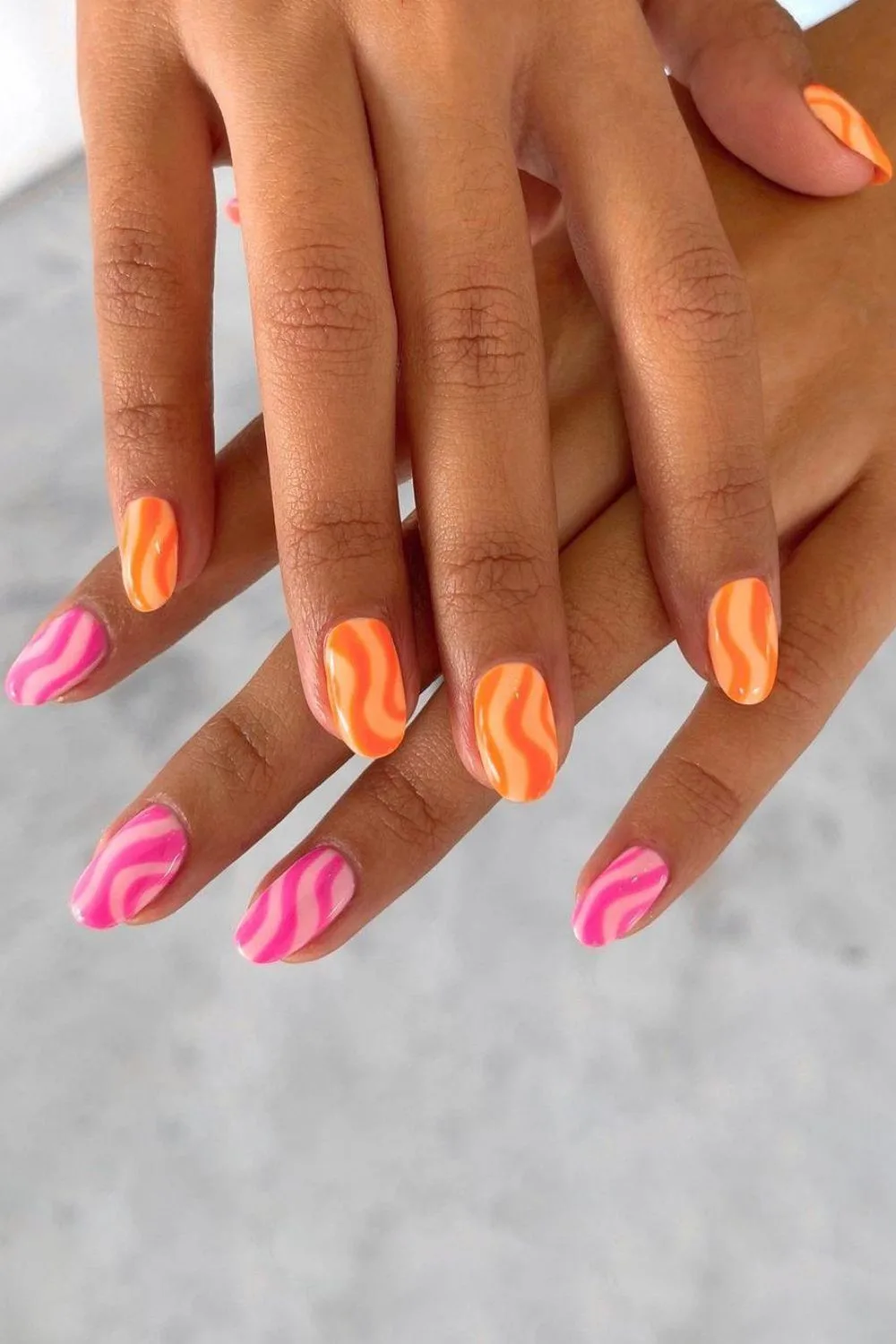 Pink and orange nails with ice cream swirls