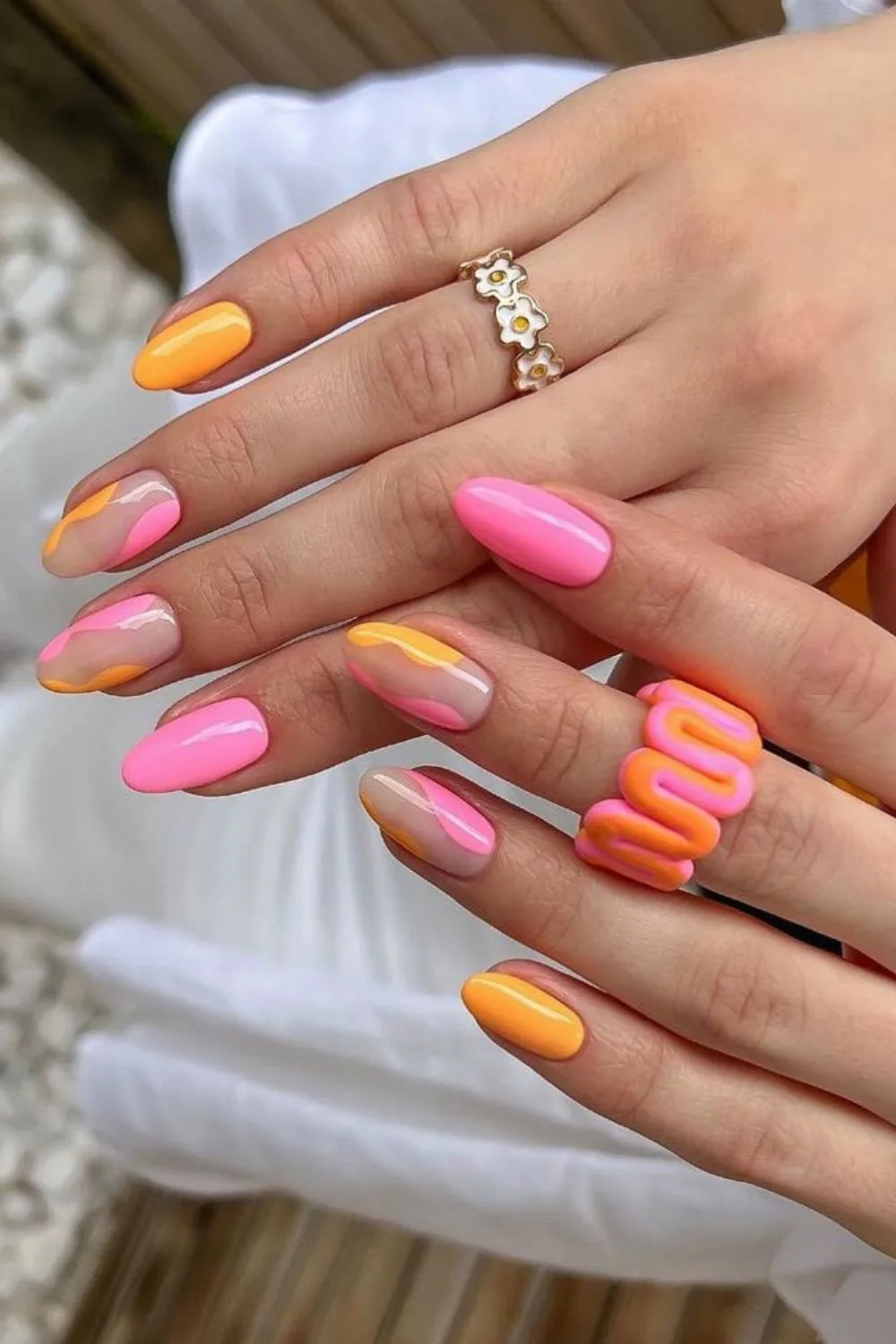 Pink and orange nails with negative space accent