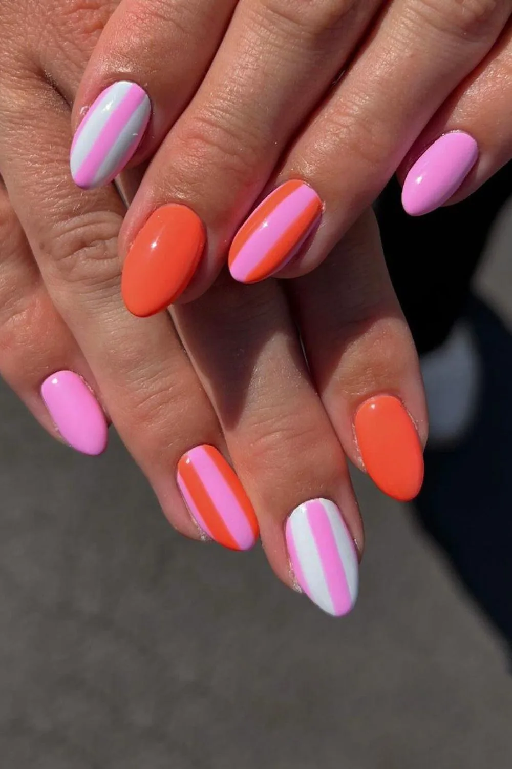 Pink and orange nails with stripes