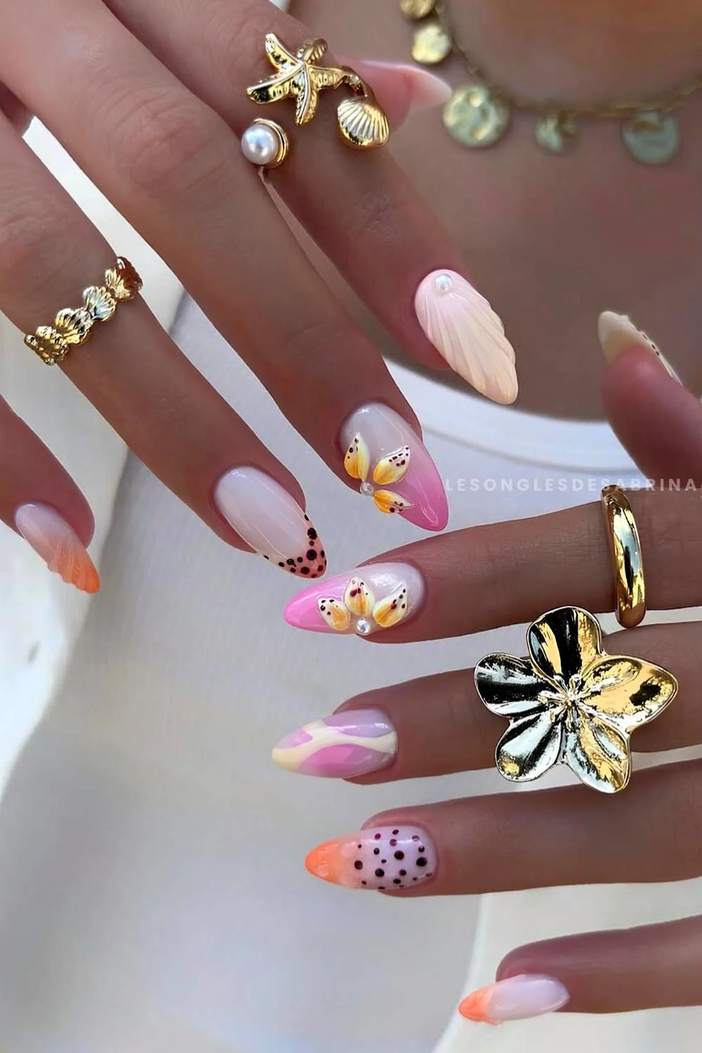 Pink and orange nails with tropical inspired accents