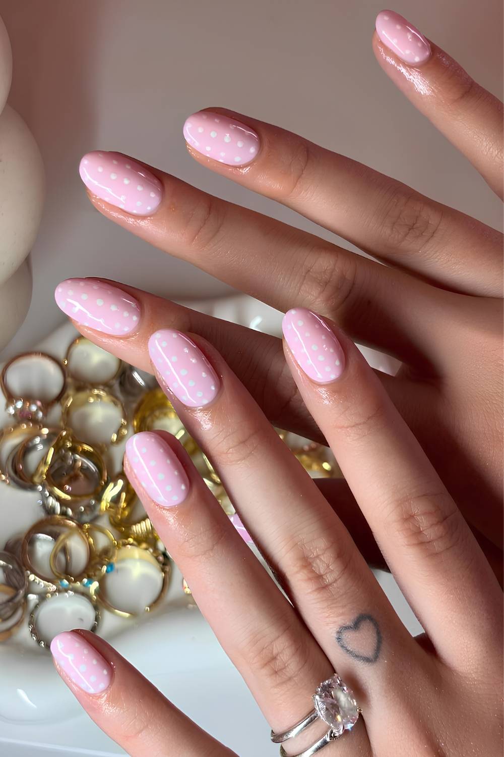 Pink nails with white polka dot art