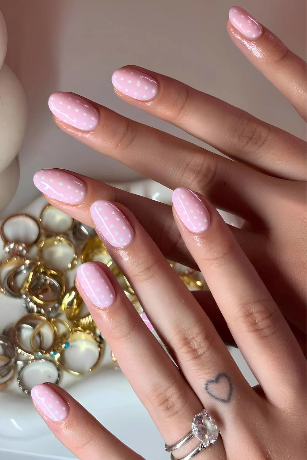 Pink nails with white polka dot art