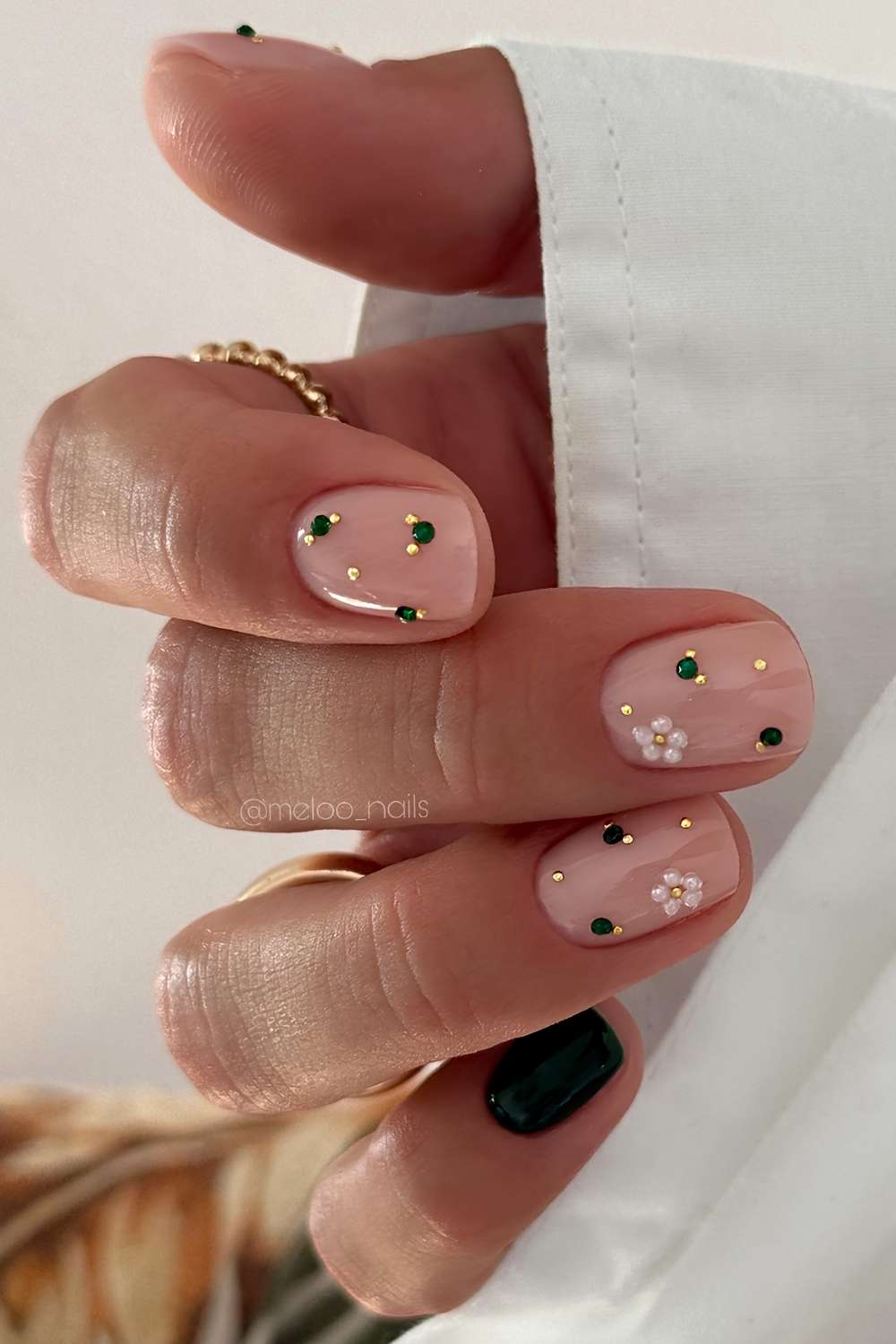 Short dark green and pink nails with pearls and gems