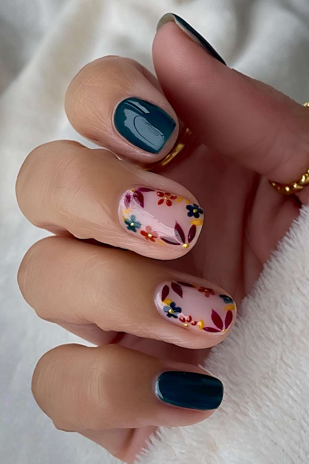 Short green nails with earthy floral art