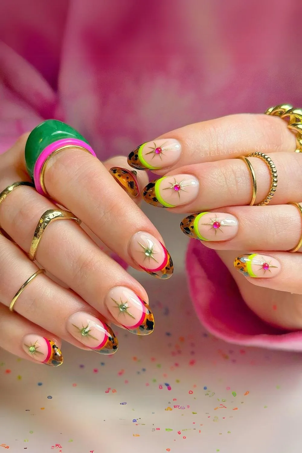 Tortoise french nails with studs and red and green outlines