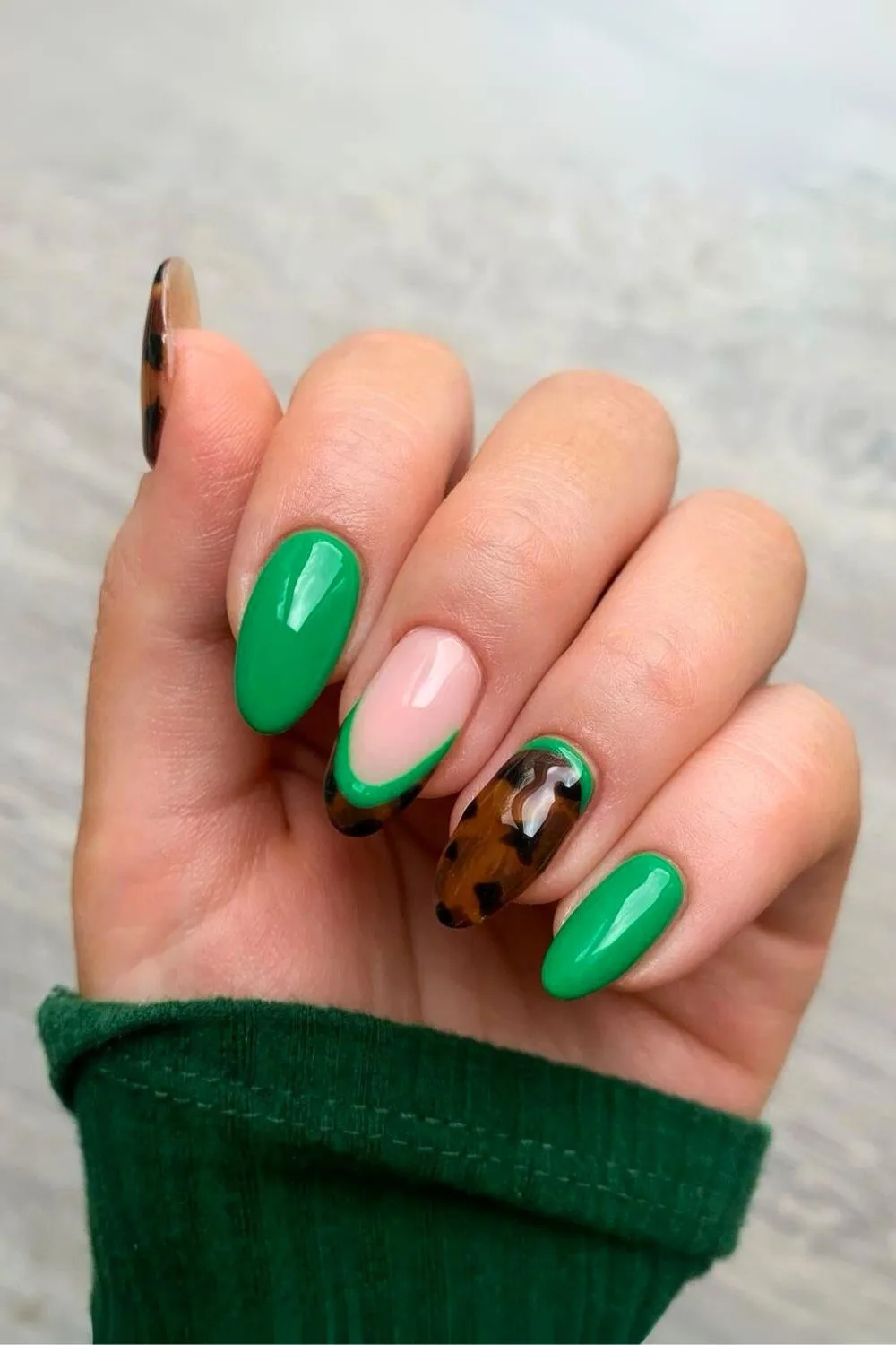 Vibrant green nails with tortoise accent