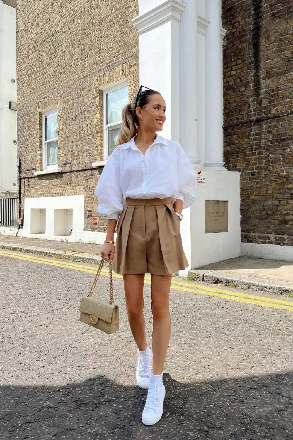 White button-up shirt and tan shorts