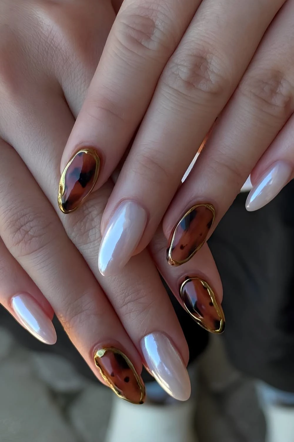 White chrome nails with tortie shell and gold accents