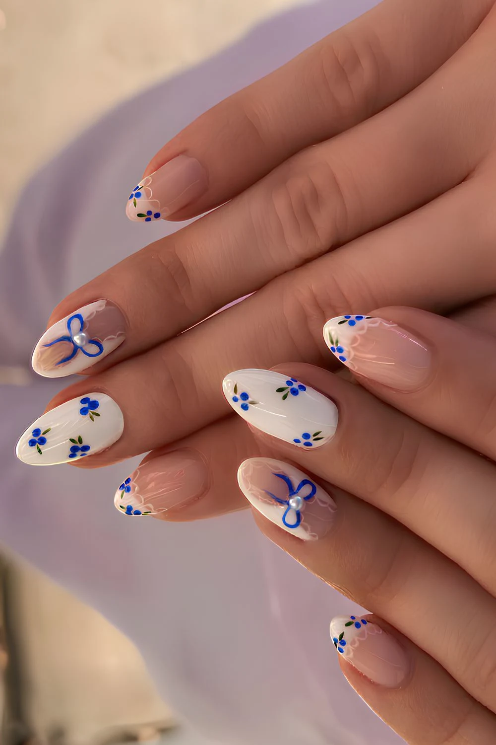 White nails with blueberry and bow art