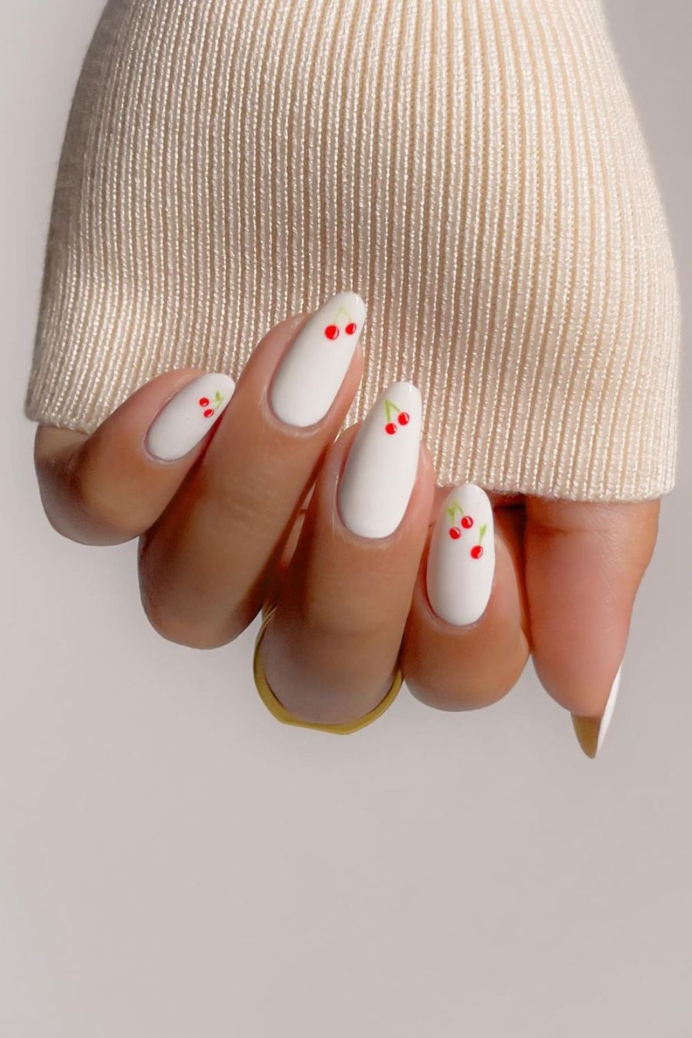 White nails with cherry accents