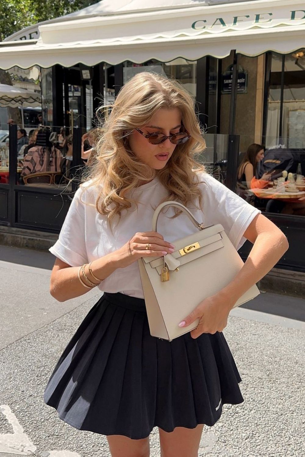 White t-shirt and black pleated skirt