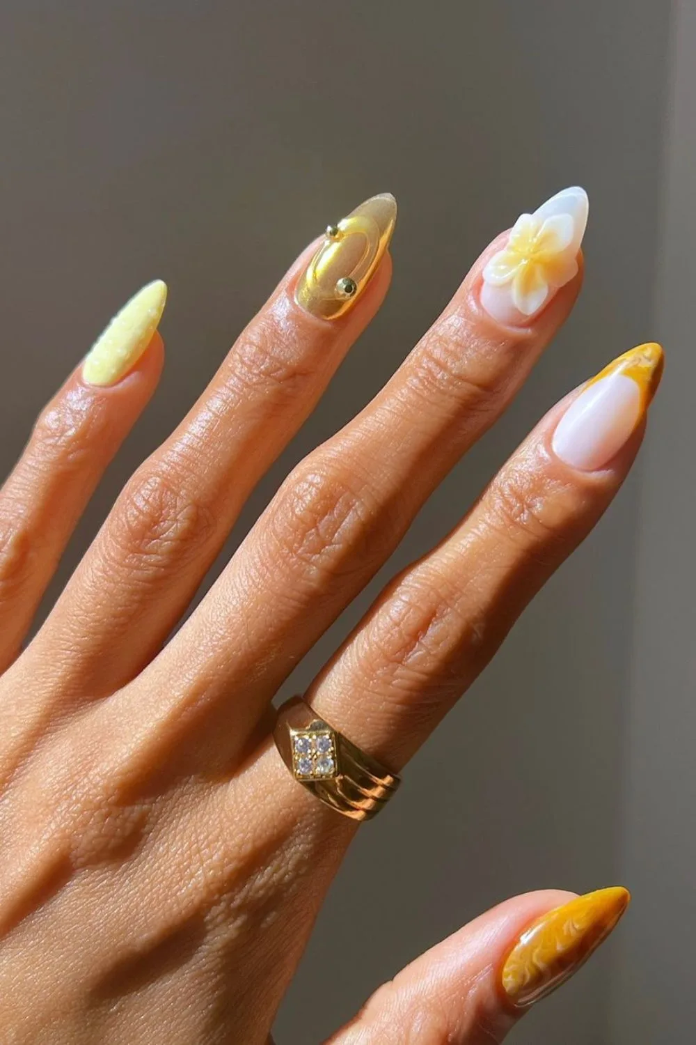 Yellow and gold nails with 3d hibiscus flower accents