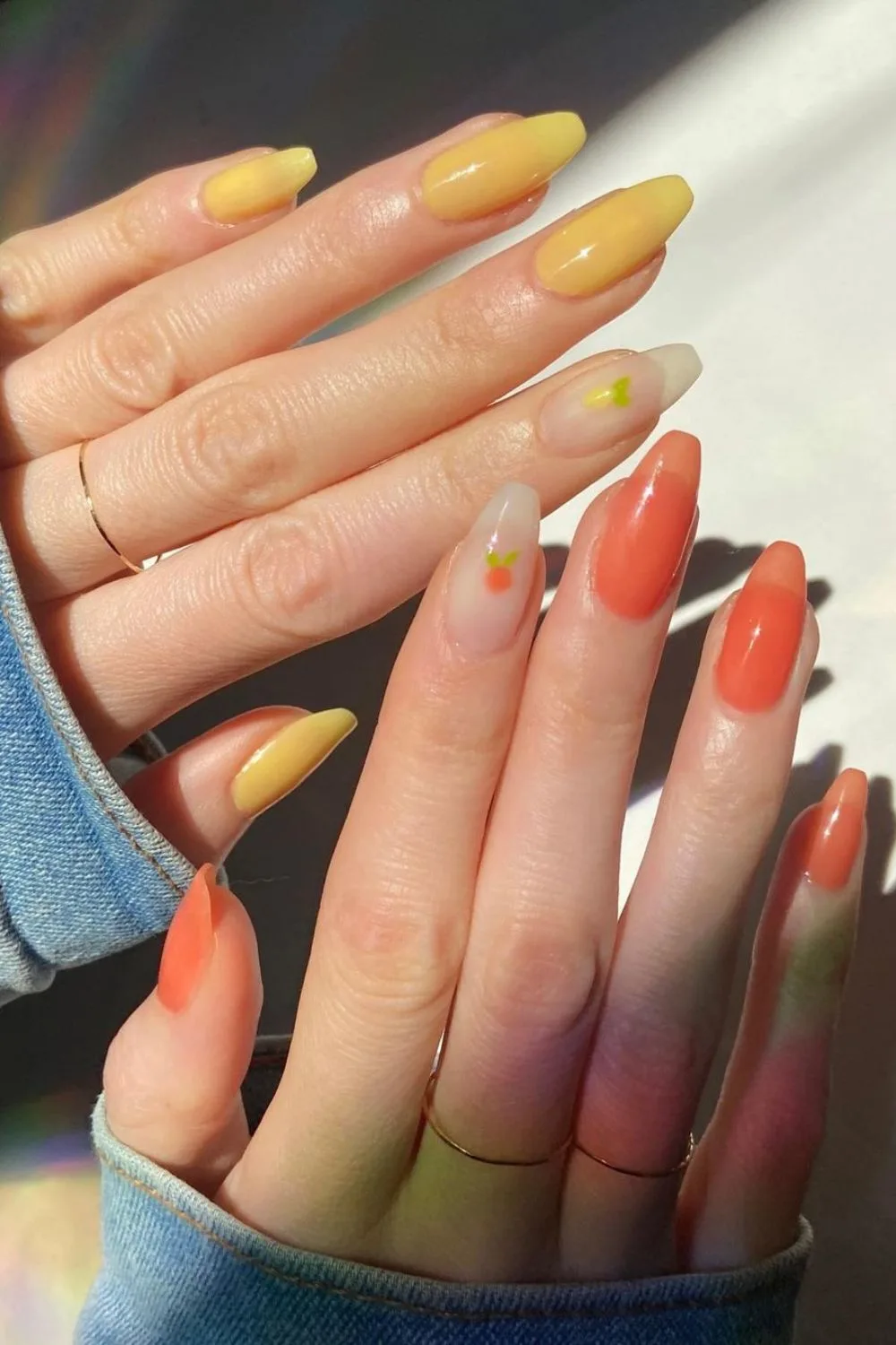 Yellow and orange nails with fruit accents