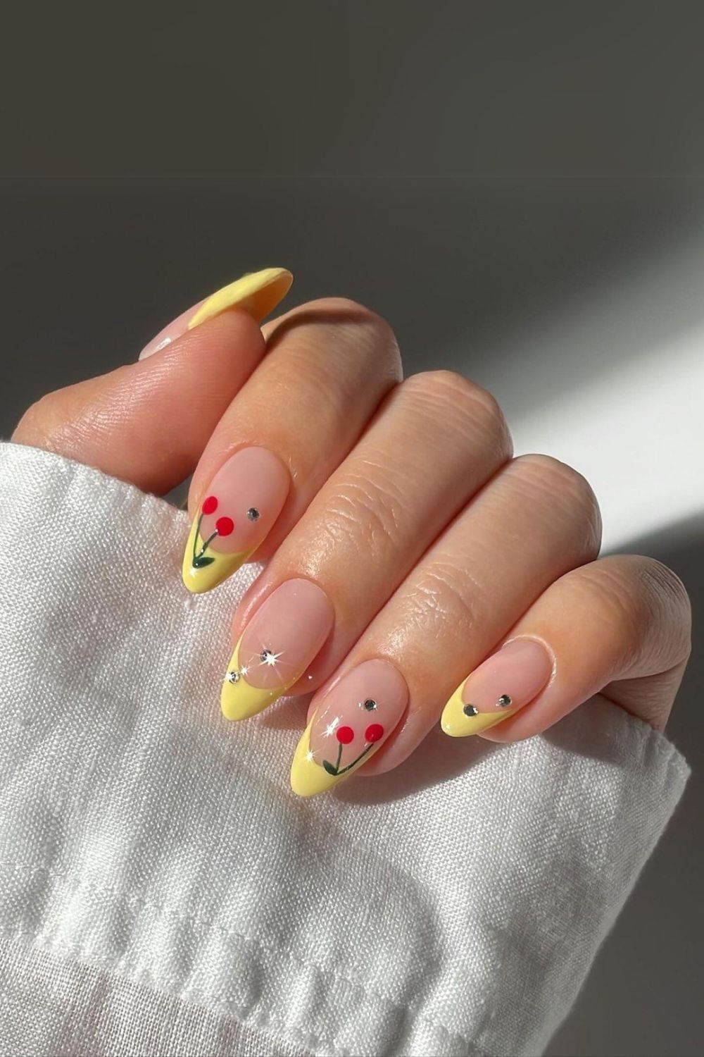 Yellow french nails with cherry accents