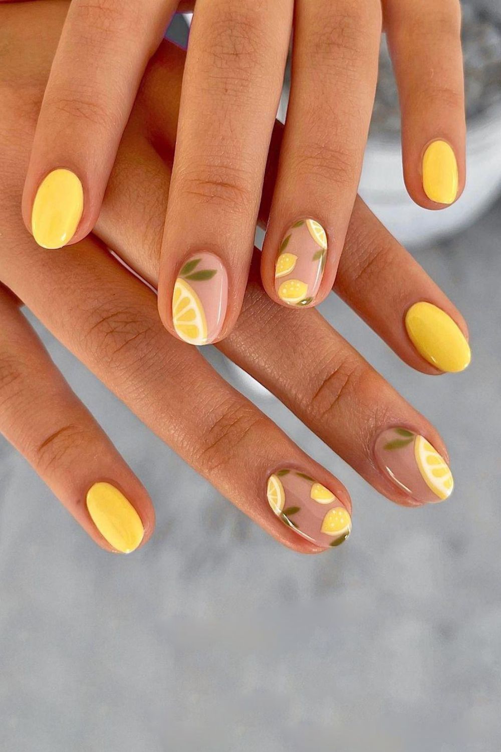 Yellow manicure with lemon designs