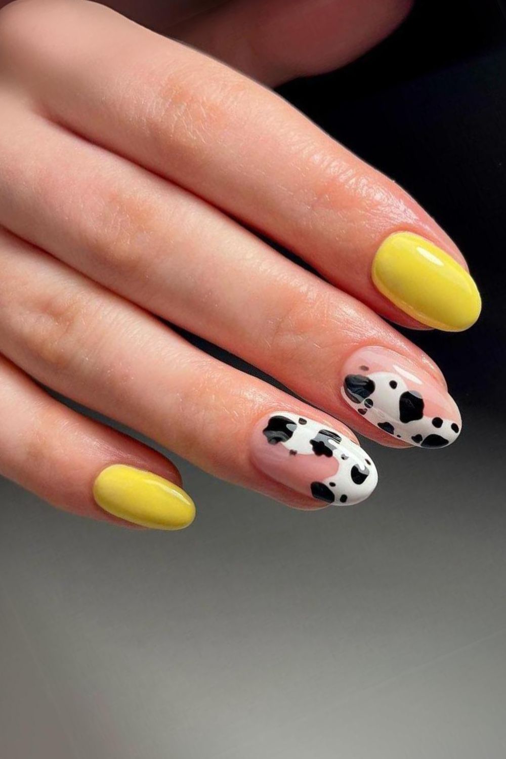 Yellow nails with cow print accent