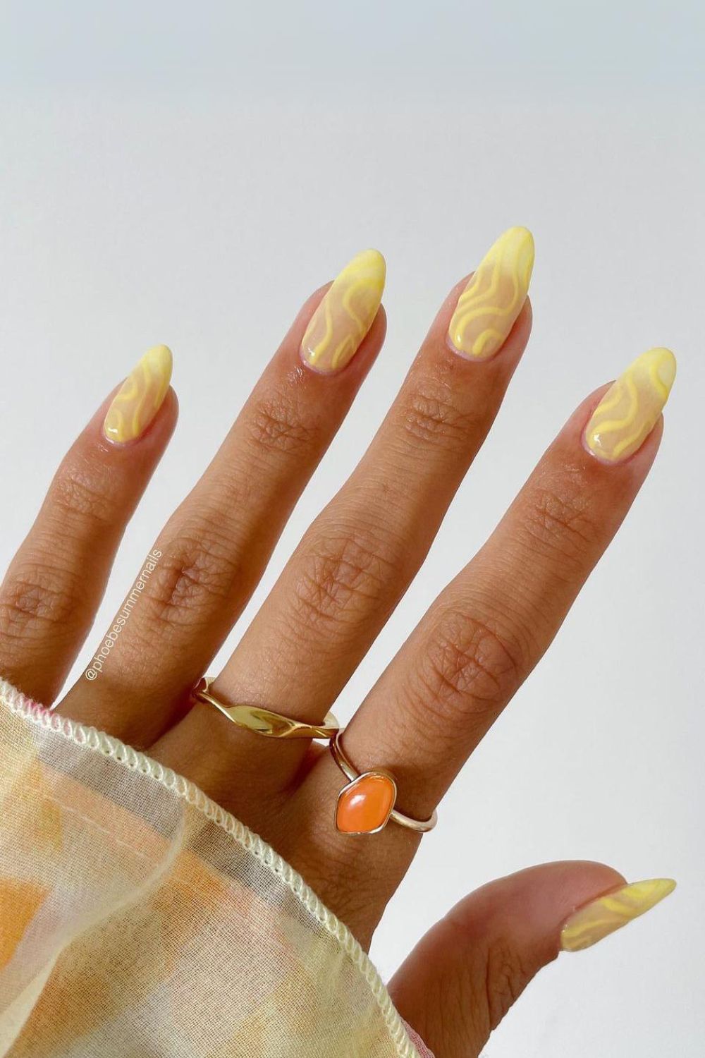 Yellow nails with funky swirls